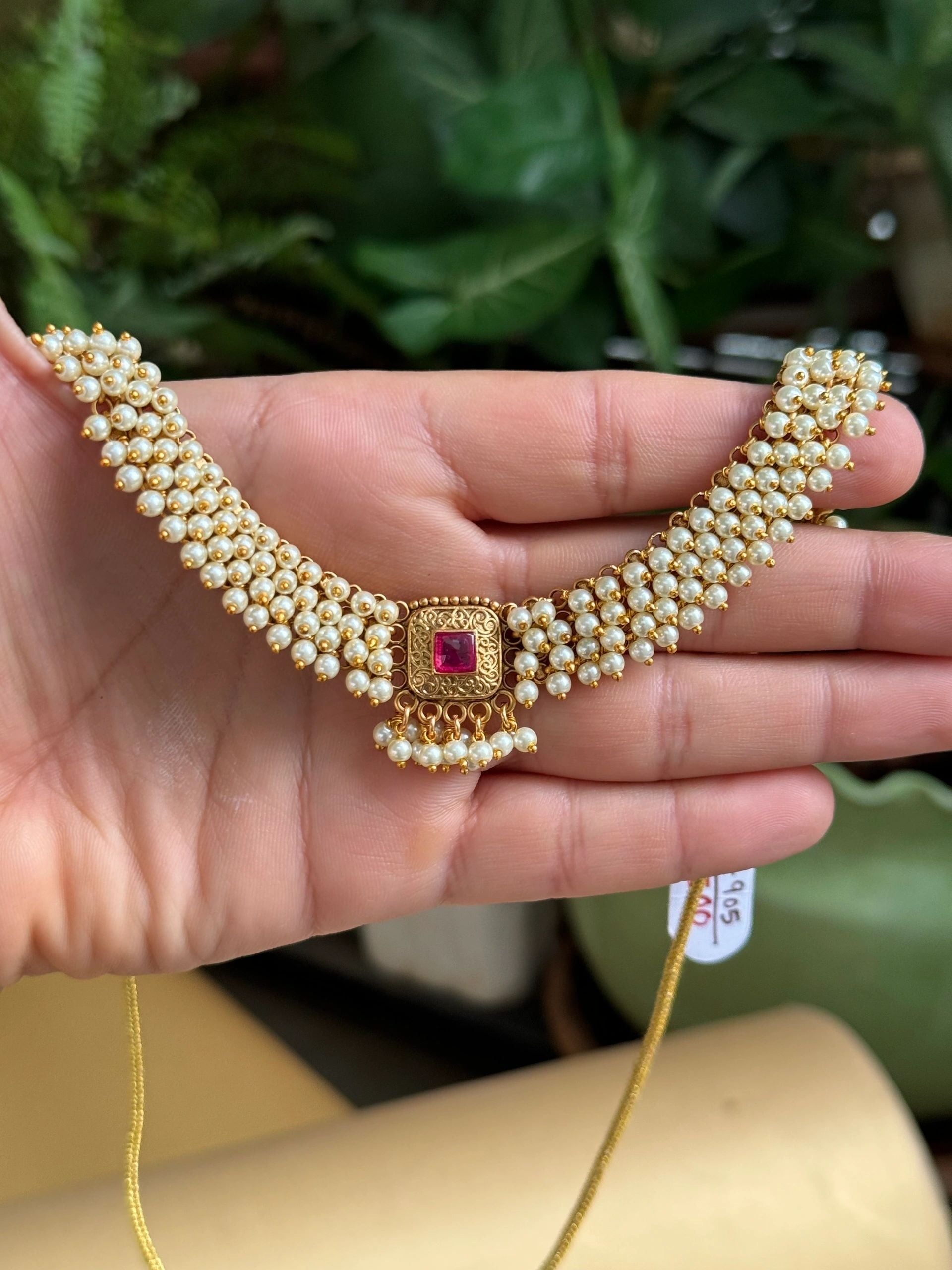 Pearl necklace with ruby centre stone and earrings